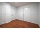 Clean bedroom with two doors and beautiful wood-look flooring at 5101 Rockbridge Rd, Stone Mountain, GA 30088