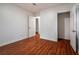 Bedroom featuring hardwood floors and an ensuite bath behind a five panel door at 5101 Rockbridge Rd, Stone Mountain, GA 30088