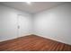 Minimalist bedroom with wood-look flooring, and a white door at 5101 Rockbridge Rd, Stone Mountain, GA 30088
