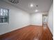 Spacious bedroom features pristine white walls and rich wood-look flooring at 5101 Rockbridge Rd, Stone Mountain, GA 30088