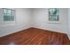 Bedroom with two windows, wood-look floors and neutral walls at 5101 Rockbridge Rd, Stone Mountain, GA 30088