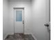 Entryway features updated flooring and a glass paned door at 5101 Rockbridge Rd, Stone Mountain, GA 30088