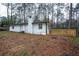 View of the back of the house showing a brick chimney and a wooden deck at 5101 Rockbridge Rd, Stone Mountain, GA 30088