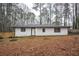 Charming single-story home featuring a white exterior, black trim, and a well-manicured yard at 5101 Rockbridge Rd, Stone Mountain, GA 30088
