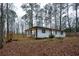Charming single-story home featuring a white exterior, black trim, and a newly constructed deck at 5101 Rockbridge Rd, Stone Mountain, GA 30088