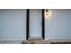 Close-up of a white front door with black trim and a stylish lantern at 5101 Rockbridge Rd, Stone Mountain, GA 30088