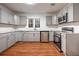 Modern kitchen with gray cabinets, stainless steel appliances, granite countertops, and hardwood floors at 5101 Rockbridge Rd, Stone Mountain, GA 30088