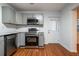 View of the modern kitchen with gray cabinets, stainless steel appliances, and hardwood floors at 5101 Rockbridge Rd, Stone Mountain, GA 30088