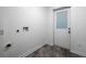 Laundry room with gray tile floors and a glass paneled exterior door at 5101 Rockbridge Rd, Stone Mountain, GA 30088