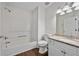 Bathroom featuring a tub-shower, toilet, and a vanity with granite counters and modern fixtures at 5135 Gable Ridge Way, Sugar Hill, GA 30518
