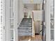Bright entryway with a staircase leading to the upper level and hardwood floors at 5135 Gable Ridge Way, Sugar Hill, GA 30518