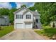 Charming two-story home with a two-car garage and a well-manicured front yard at 5135 Gable Ridge Way, Sugar Hill, GA 30518