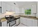 Updated kitchen featuring stainless steel appliances and white cabinets at 5135 Gable Ridge Way, Sugar Hill, GA 30518