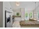 Modern kitchen featuring stainless steel appliances and granite countertops at 5135 Gable Ridge Way, Sugar Hill, GA 30518