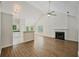 Open-concept living area featuring vaulted ceilings, fireplace, and modern flooring at 5135 Gable Ridge Way, Sugar Hill, GA 30518