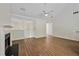 Bright living room showing hardwood floors, fireplace, and stairs at 5135 Gable Ridge Way, Sugar Hill, GA 30518