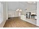 Open concept living area features hardwood floors and stainless steel appliances at 5135 Gable Ridge Way, Sugar Hill, GA 30518