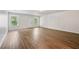 Spacious living room featuring wood floors, white walls, and large windows for ample light at 5135 Gable Ridge Way, Sugar Hill, GA 30518