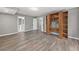 Large open basement with vinyl flooring, built-in shelving and access to a bathroom and additional rooms at 515 Old Chartwell Xing, Alpharetta, GA 30022