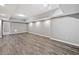 Spacious basement featuring modern gray vinyl flooring and recessed lighting, perfect for entertaining at 515 Old Chartwell Xing, Alpharetta, GA 30022