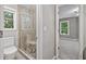 Bathroom showcasing a glass shower, toilet, and open doorway to bedroom at 515 Old Chartwell Xing, Alpharetta, GA 30022