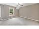 Bedroom featuring a window, neutral walls, carpet, and modern ceiling fan at 515 Old Chartwell Xing, Alpharetta, GA 30022