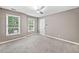 Bedroom featuring neutral walls, carpet, ceiling fan, two windows, and white trim at 515 Old Chartwell Xing, Alpharetta, GA 30022