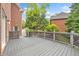Wide view of home's gray deck area with lattice railing overlooking backyard at 515 Old Chartwell Xing, Alpharetta, GA 30022
