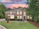 Stunning two-story brick home with manicured lawn, mature trees, and classic architectural details at 515 Old Chartwell Xing, Alpharetta, GA 30022
