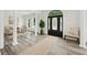 Elegant foyer with decorative front door, columns, and light gray wood floors creating a grand entrance at 515 Old Chartwell Xing, Alpharetta, GA 30022