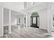 Grand foyer with two story ceiling, decorative front door with sidelights, and classic architectural details at 515 Old Chartwell Xing, Alpharetta, GA 30022