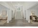 Bright foyer boasts soaring ceilings, a grand staircase, and beautiful flooring at 515 Old Chartwell Xing, Alpharetta, GA 30022