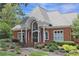 Traditional brick home with grand entrance, complemented by manicured landscaping and inviting curb appeal at 515 Old Chartwell Xing, Alpharetta, GA 30022