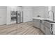 This kitchen has stainless appliances, and a center island with a modern sink and faucet at 515 Old Chartwell Xing, Alpharetta, GA 30022