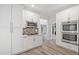 Bright kitchen with stainless appliances, white cabinets, and decorative backsplash at 515 Old Chartwell Xing, Alpharetta, GA 30022