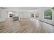 Bright, open-concept living area featuring a modern kitchen, light gray wood floors, and abundant natural light at 515 Old Chartwell Xing, Alpharetta, GA 30022