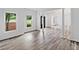 Open living room featuring hardwood style flooring, columns, and large windows at 515 Old Chartwell Xing, Alpharetta, GA 30022