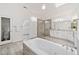 Stylish main bath featuring a soaking tub, a skylight, walk-in shower and sleek vanity with granite countertops at 515 Old Chartwell Xing, Alpharetta, GA 30022