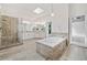Bright main bath with a soaking tub, a skylight, and walk-in shower with dual shower heads at 515 Old Chartwell Xing, Alpharetta, GA 30022