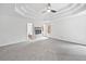 Large main bedroom features a tray ceiling, fireplace and a carpeted floor at 515 Old Chartwell Xing, Alpharetta, GA 30022