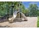 Community playground featuring a slide and climbing stairs with wood chip ground cover at 515 Old Chartwell Xing, Alpharetta, GA 30022