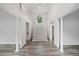 Striking staircase with white risers and light gray wood treads under a large picture window at 515 Old Chartwell Xing, Alpharetta, GA 30022
