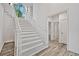 Beautiful stairway with hardwood-style flooring and white trim with modern doors at 515 Old Chartwell Xing, Alpharetta, GA 30022
