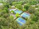 Aerial view of tennis courts and pool area in a lush community surrounded by mature trees at 515 Old Chartwell Xing, Alpharetta, GA 30022