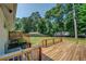 Large wooden deck with steps down to the spacious backyard with mature trees at 1399 Pollard Sw Dr, Atlanta, GA 30311