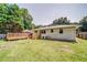 Spacious backyard featuring a wooden deck, lush green lawn, and mature trees at 1399 Pollard Sw Dr, Atlanta, GA 30311