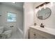 Bathroom featuring a shower/tub combo, black hardware and a large vanity at 1399 Pollard Sw Dr, Atlanta, GA 30311