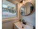 Bathroom vanity with modern mirror and natural light from the window at 1399 Pollard Sw Dr, Atlanta, GA 30311