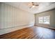 Bedroom featuring hardwood floors, ceiling fan, and a large window at 1399 Pollard Sw Dr, Atlanta, GA 30311