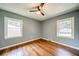 Bedroom with hardwood floors, ceiling fan, and two large windows at 1399 Pollard Sw Dr, Atlanta, GA 30311